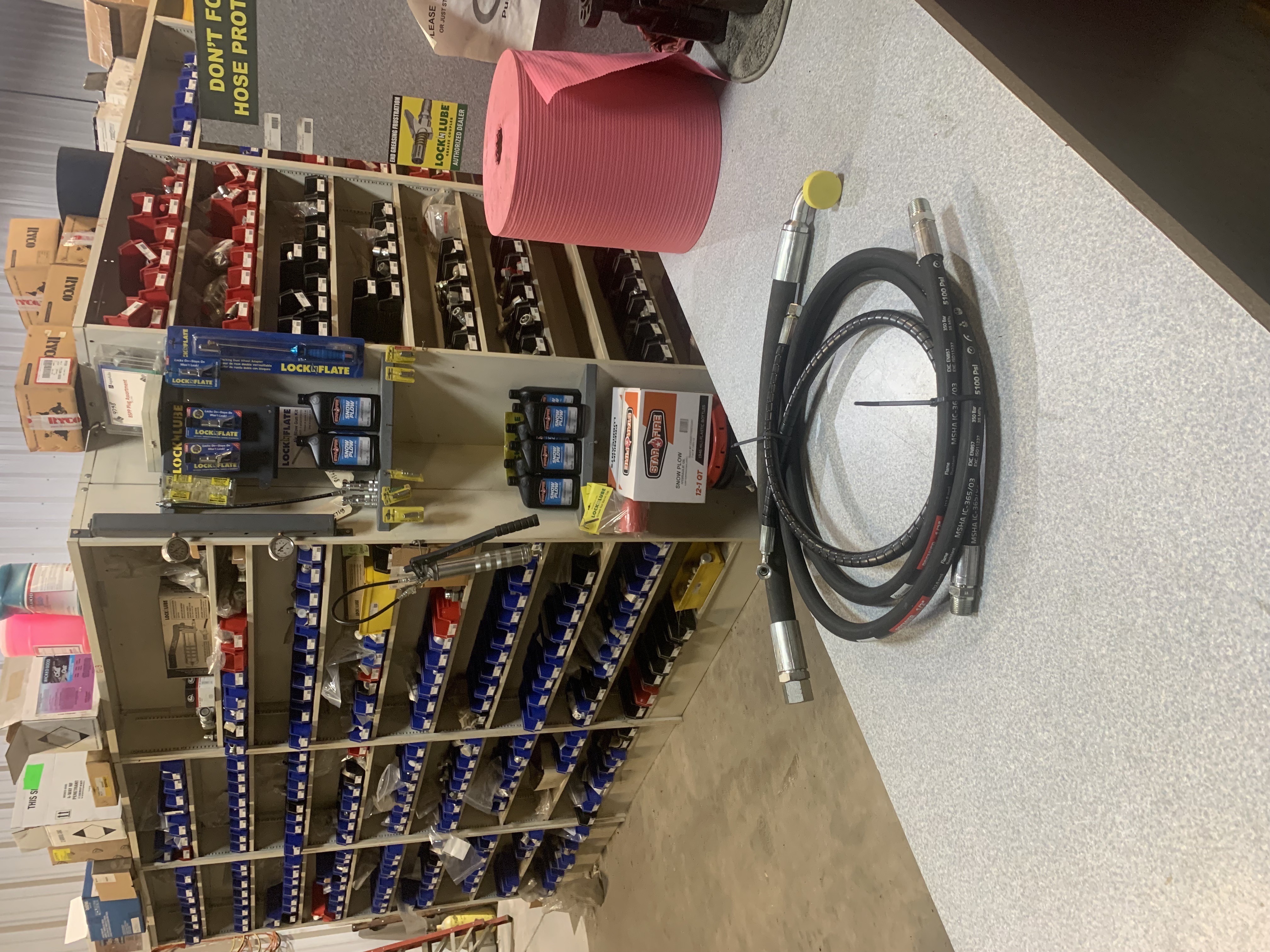 Hydramachine inventory shelves with hydraulic fittings and hose assemblies